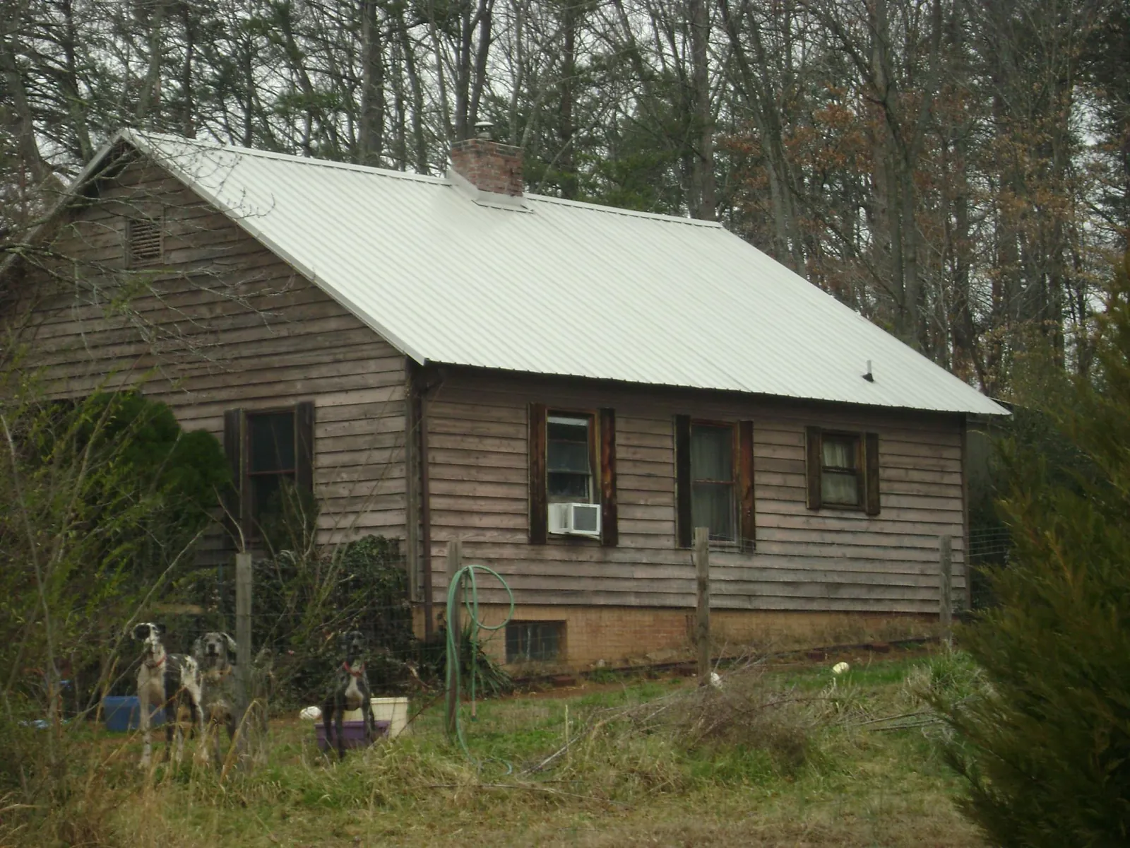 White metal roof on an old wood sided farmhouse, from a Metal Roof Installation job in Pine City