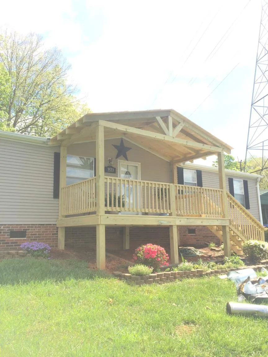 New gabled porch roof and deck railing added to a ranch home in Pine City